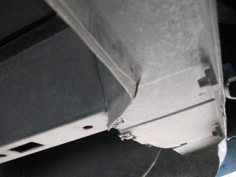 1978 Ford E250 - Close-up view of the undercarriage of a vehicle, showing structural components and signs of wear.
