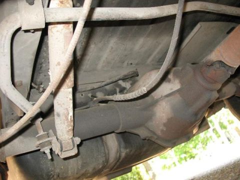 1978 Ford E250 - The underside of a vehicle is visible, including suspension and drivetrain components.