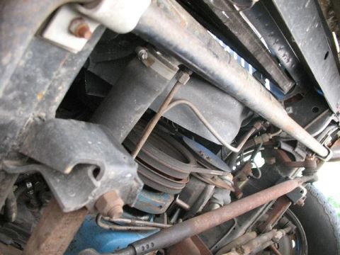 1978 Ford E250 - Close-up of the undercarriage reveals mechanical components and suspension parts.