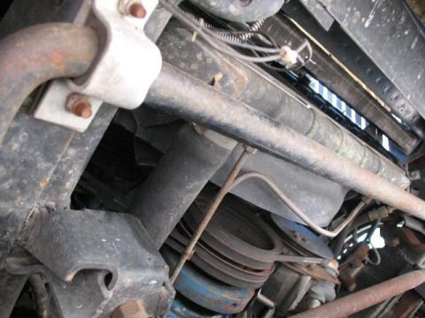 1978 Ford E250 - The undercarriage of a 1978 Ford E250 reveals its suspension and engine parts.