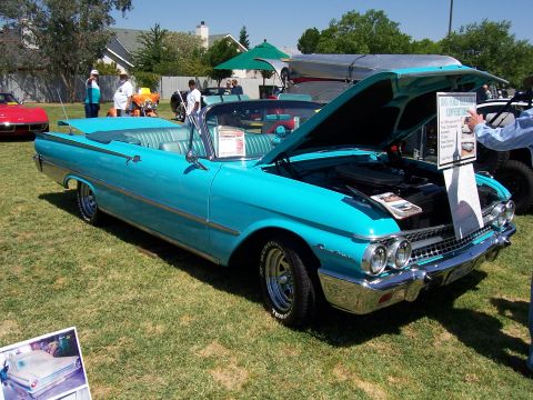 2002 Ford Mustang - A turquoise 1959 Ford Fairlane convertible is displayed with its hood open at an outdoor event.