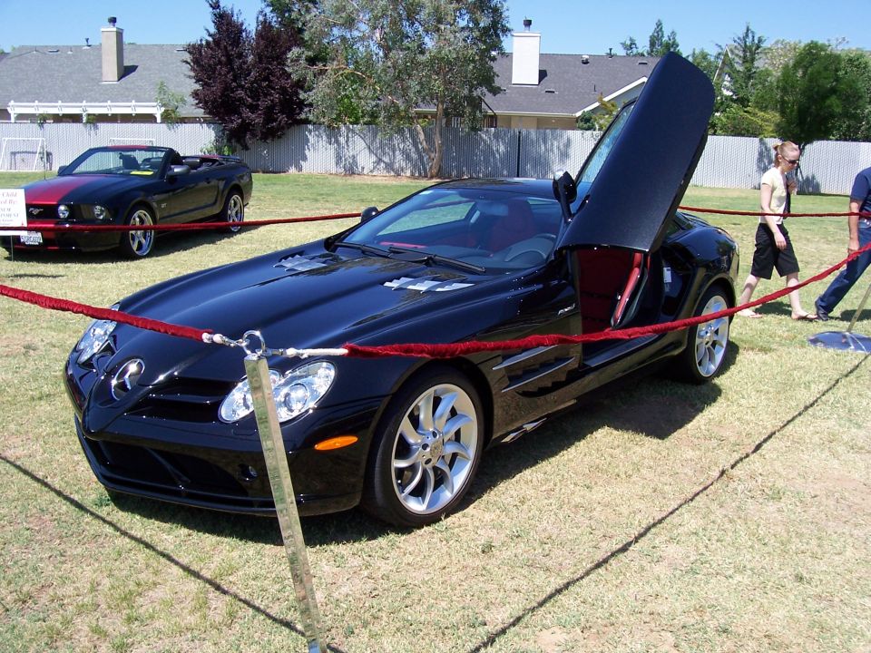 Black sports car with butterfly doors and red interior
