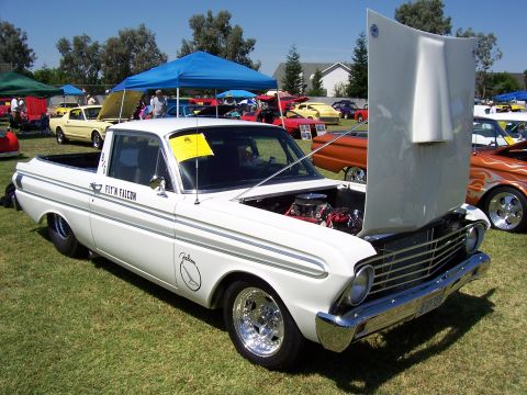 2002 Ford Mustang - A white Ford Falcon pickup truck is displayed with its hood open at an outdoor car show.
