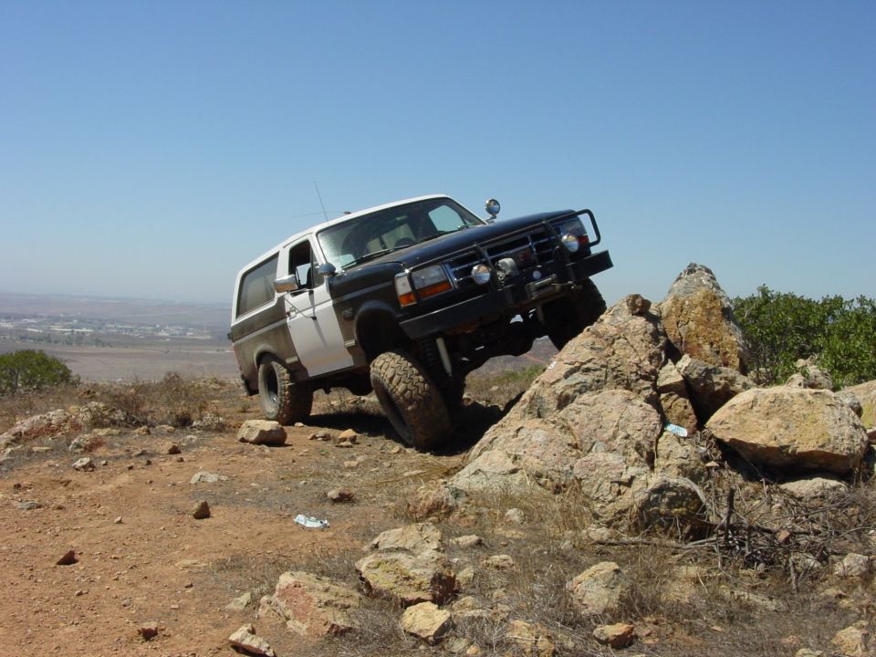 1994 Ford Bronco climbing rocks on a sunny day