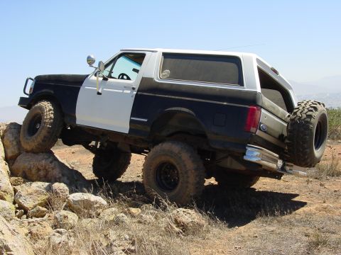 1994 Ford Bronco - This modified 1994 Ford Bronco navigates a rocky trail with its front wheels elevated.