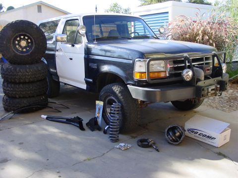 1994 Ford Bronco - Ford Bronco with new suspension parts and tires staged for installation.