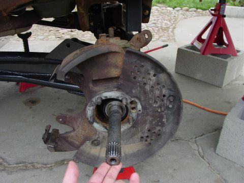 1994 Ford Bronco - Close-up of a vehicle's front wheel hub assembly, showing the splined axle shaft and brake rotor mounting points.