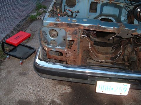 1990 Ford Ranger - Front view of a heavily rusted truck, likely from the 1980s, undergoing disassembly.