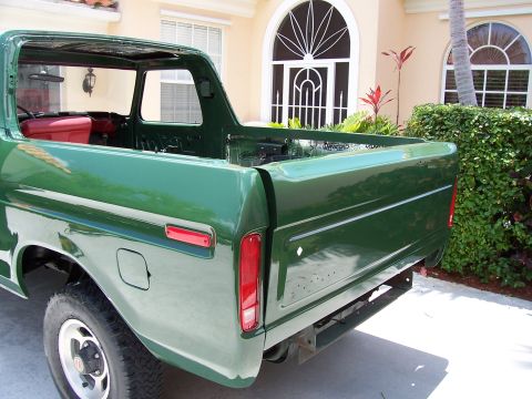 1978 Ford Bronco - Rear view of a green 1978 Ford Bronco, showing the quarter panel and tailgate.