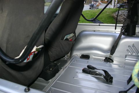 2003 Jeep TJ - The interior of a silver Jeep TJ shows a roll cage and black seats.