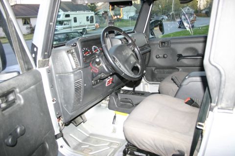 2003 Jeep TJ - Interior view of a 2003 Jeep TJ, showing the dashboard, steering wheel, and seats.