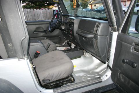 2003 Jeep TJ - Interior view of a 2003 Jeep TJ, highlighting the seats and dashboard.