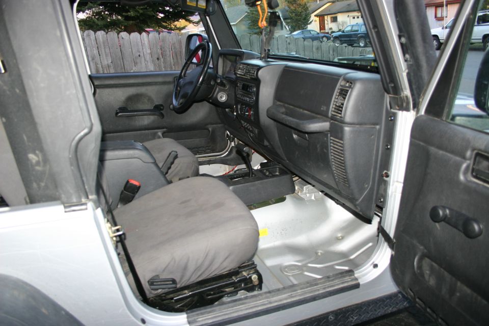 2003 Jeep TJ interior showing front seats, dashboard, and door panel