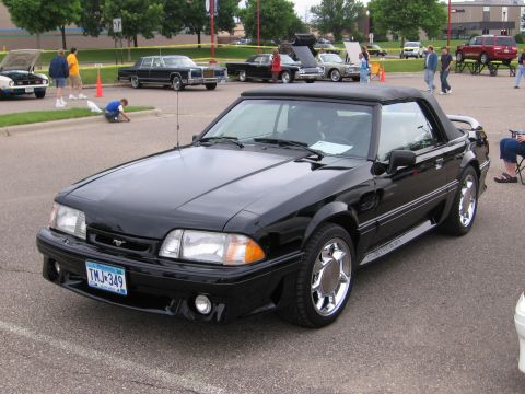 1989 Ford Mustang - Black 1989 Ford Mustang GT convertible at a car show, with other cars visible.