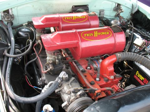 1940 Chevrolet Suburban - Close-up view of an engine bay, highlighting the dual H-Power air intake system and associated components.