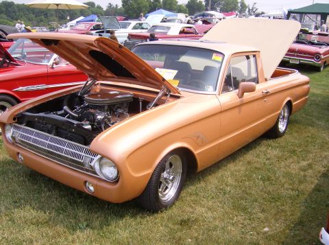 1970 Ford Ranchero - A classic Ford Falcon Ranchero is displayed with its engine exposed at an outdoor car show.