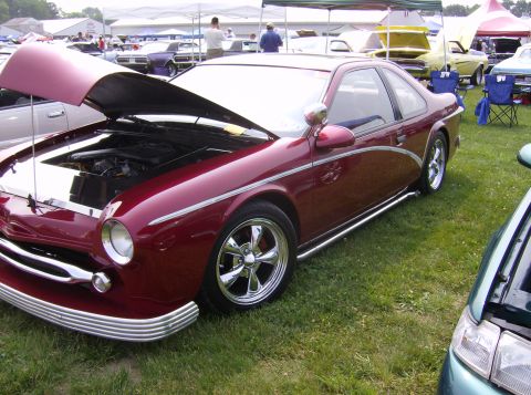 1970 Ford Ranchero - A custom coupe with its hood open sits on display at an outdoor car show.
