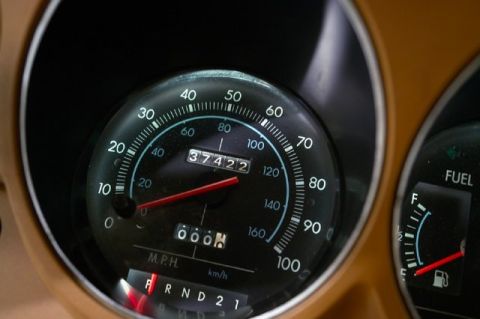 1978 Ford E250 - Interior view of a vehicle's dashboard, a speedometer and fuel gauge.