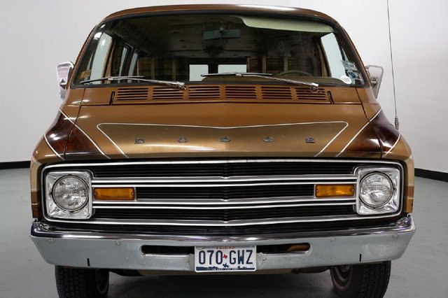 Front view of a 1977 Dodge van with a chrome grille and a license plate reading 070-GWZ