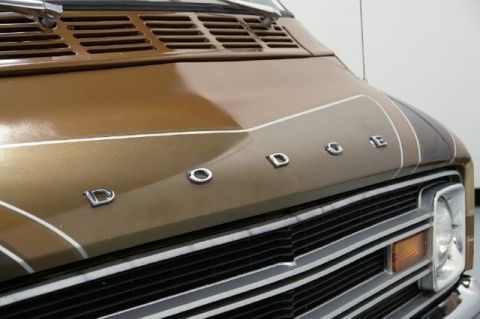 1978 Ford E250 - The chrome Dodge lettering is visible on the hood of this brown van.