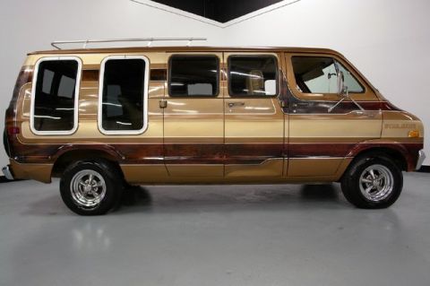 1978 Ford E250 - This van, with its distinctive wood-grain paneling and custom windows, appears to be from the 1970s.
