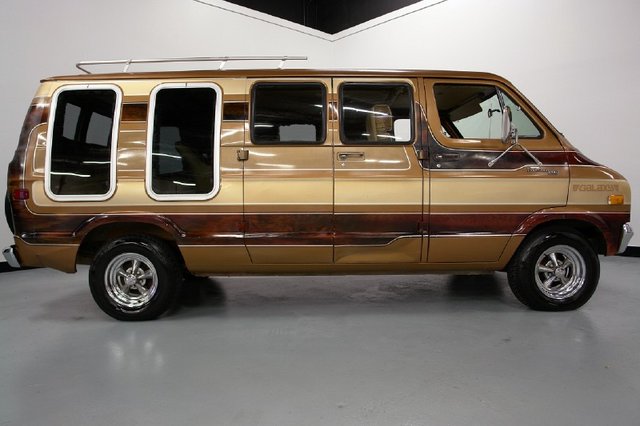 Brown and gold striped van with custom windows and chrome wheels, seen from the side