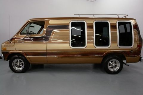 1978 Ford E250 - This van features a distinctive two-tone brown paint scheme with wood grain accents and custom window treatments.
