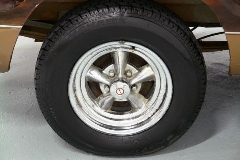 1978 Ford E250 - Close-up of a chrome five-spoke wheel and tire, likely from a van or truck.