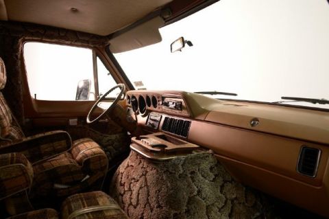 1978 Ford E250 - The interior of a van features plaid upholstery and a unique shag-covered center console.