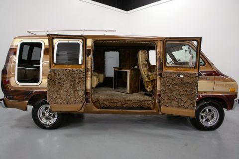 1978 Ford E250 - This 1978 Ford E250 features a custom interior with shag carpet and plaid upholstery, a unique van conversion.