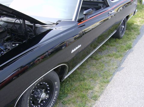 1970 Ford Ranchero - A black 1970 Ford Ranchero is shown with its hood open, revealing the engine compartment.