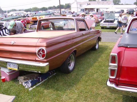 1970 Ford Ranchero - A classic Ford Falcon Ranchero is displayed at an outdoor event with other vehicles and people around.