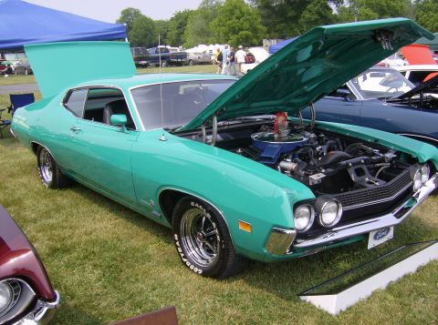 1970 Ford Ranchero - A teal 1970 Ford Torino GT is displayed with its hood open, revealing the engine bay.