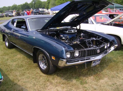 1970 Ford Ranchero - A blue 1970 Ford Ranchero is displayed with its hood open, revealing the engine and a "Ford Country" license plate.