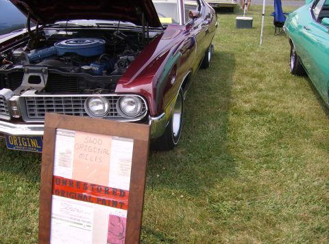 1970 Ford Ranchero - A 1970 Ford Ranchero is displayed with its engine exposed, next to another vehicle.
