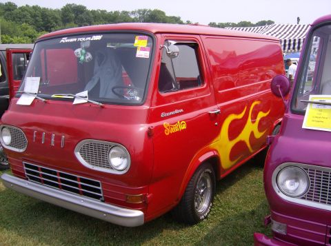 1970 Ford Ranchero - A red Ford Econoline van with custom flame decals is parked next to a purple vehicle.