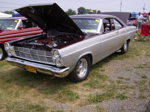 1970 Ford Ranchero - A two-tone coupe is displayed with its hood open, revealing the engine bay.