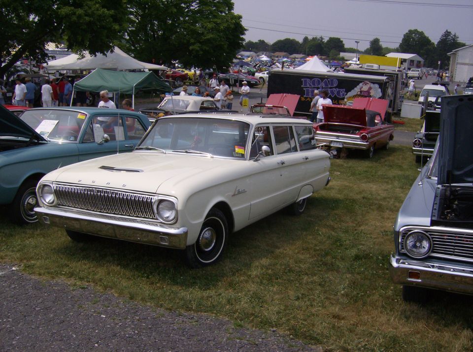 White station wagon, front 3/4 view, with a prominent grille