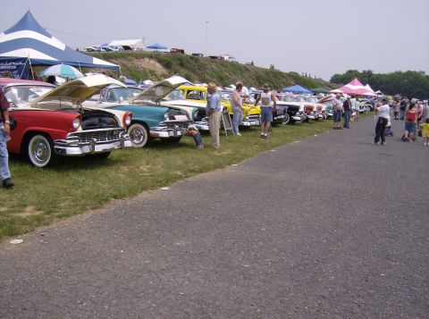 1970 Ford Ranchero - A row of vintage automobiles are displayed outdoors under tents and clear skies.