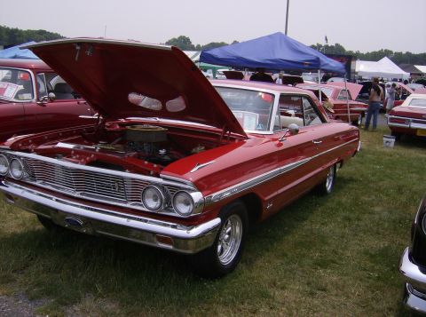 1970 Ford Ranchero - A red 1964 Ford Galaxie is displayed with its hood open at an outdoor event.