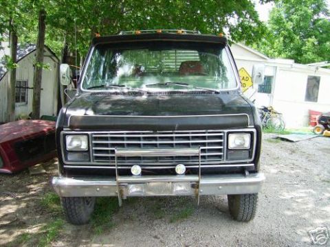1978 Ford E250 - This 1978 Ford E250 van is presented from a front-facing perspective, highlighting its chrome grille and bumper.