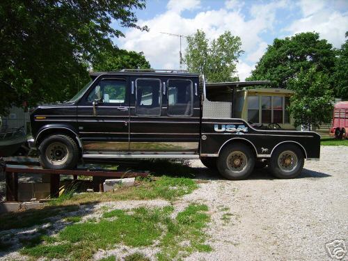 black custom van with extended cab and flatbed, dual rear wheels