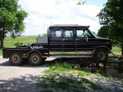 1978 Ford E250 - This modified 1978 Ford E250 features an extended cab and a dual-rear-wheel flatbed, viewed from its side.