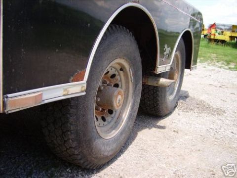 1978 Ford E250 - Rear wheels and fender of a trailer are shown in this close-up view.