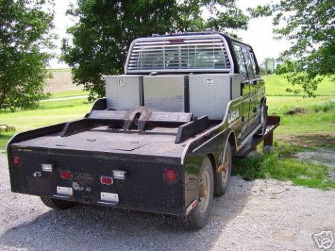 1978 Ford E250 - Rear view of a 1978 Ford E250 flatbed truck with dual rear wheels and a fifth wheel hitch.