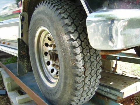 1978 Ford E250 - Detail shot of a truck's wheel, tire, and front fender area.