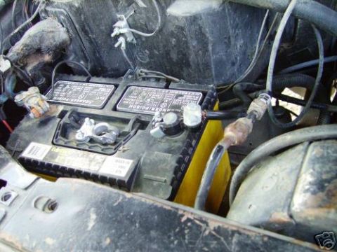 1978 Ford E250 - Close-up view of a vehicle's engine bay, focusing on the battery and associated wiring.