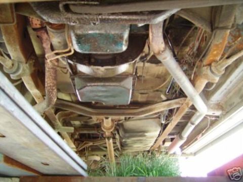 1978 Ford E250 - Underside view of a vehicle's drivetrain components, including exhaust and fuel tank.