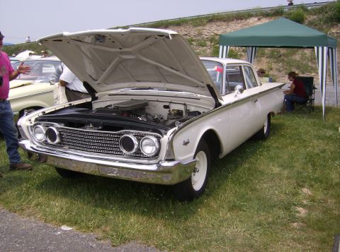 1970 Ford Ranchero - White 1960 Ford Falcon on display with hood up, parked on grass.