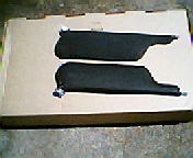 1973 Ford Ranchero - A pair of sun visors are presented on a flat surface, likely for sale or storage.